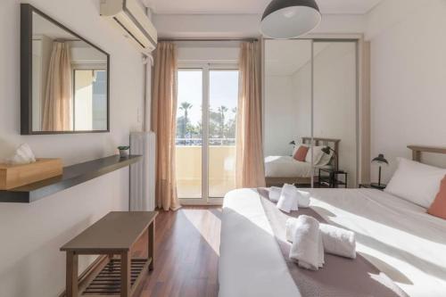 a bedroom with a bed and a table and a mirror at The HostMaster Beachside Retreat in Vari