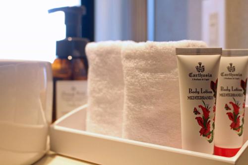 a shelf with towels and other bathroom products on it at Best Western Plus Nagoya Sakae in Nagoya