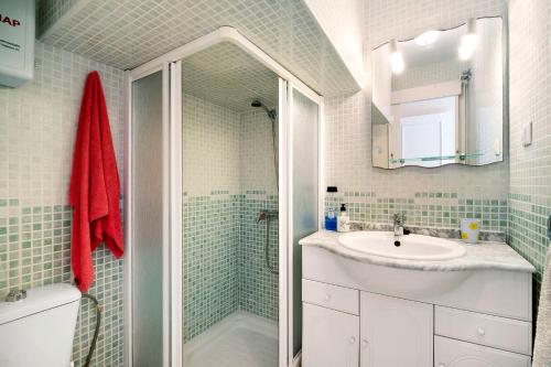 a bathroom with a shower and a sink and a mirror at Villa Valdelagrana in El Puerto de Santa María