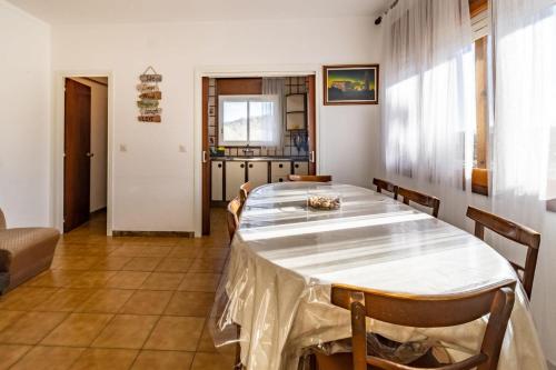 a dining room with a table and chairs at Can Pons De Dalt Casa rural a la Selva in Girona