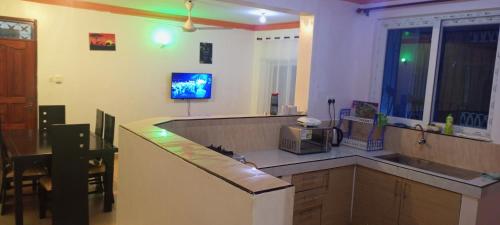 a kitchen with a counter top with a microwave at Lovely and spacious apartment with swimming pool in Mtwapa