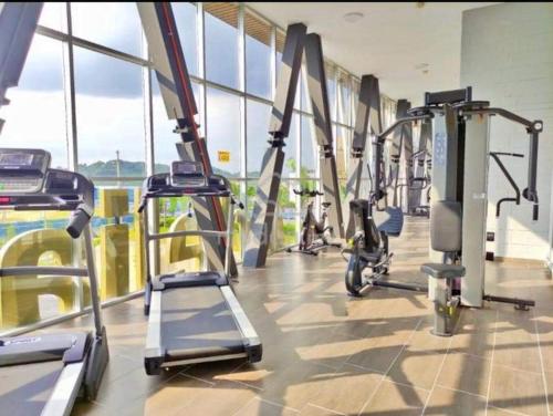 a gym with treadmills and machines in a building at NurAz Residensi Adelia2, Bangi Avenue, Free wifi, Pool in Kajang