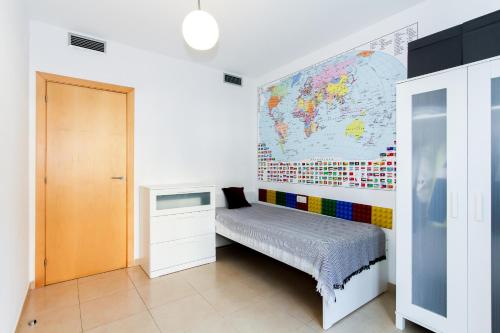 a bedroom with a map of the world on the wall at Apartment Mikki in Lloret de Mar