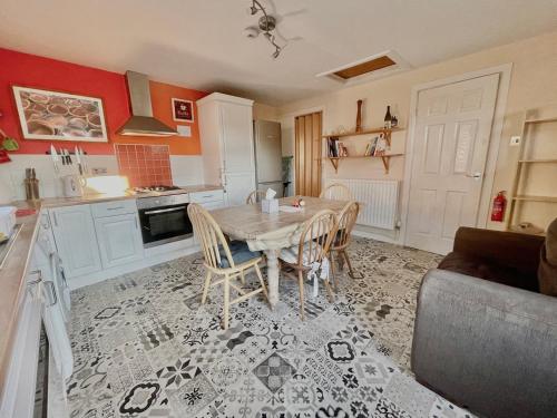 a kitchen with a table and chairs in a room at GuestReady-Close To Leeds City, Spacious, Sleeps 6 in Leeds
