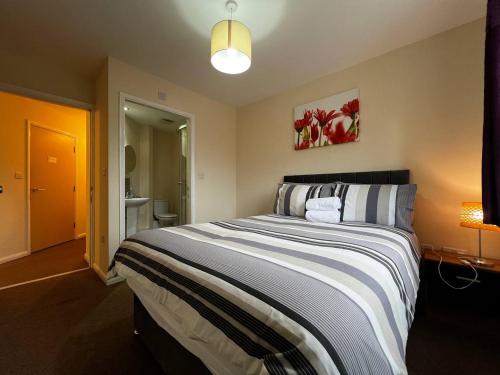 a bedroom with a large bed in a room at Crownford Guesthouse - Close to Hanley centre and University in Stoke on Trent