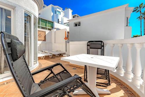 a white table and a chair on a balcony at Villa Las Mimosas in Adeje