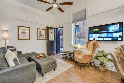a living room with a couch and a tv at Miners Anvil - Steps to Historic District in Colorado Springs