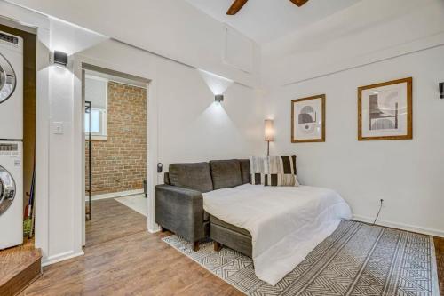 a bedroom with a bed and a couch at Miners Anvil - Steps to Historic District in Colorado Springs
