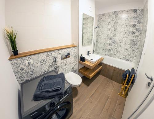 a small bathroom with a toilet and a sink at Urban Jungle in the City Center in Timişoara