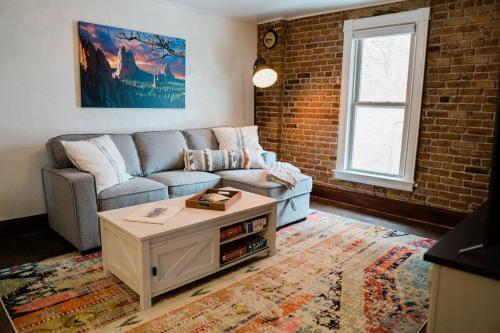 a living room with a couch and a coffee table at Miners Bend - Historic Locale Scenic Workspace in Colorado Springs