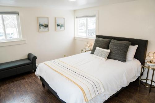 a bedroom with a large bed and a black chair at Miners Bend - Historic Locale Scenic Workspace in Colorado Springs