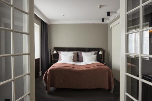 a bedroom with a bed with white pillows at Hotel Skt. Annæ in Copenhagen