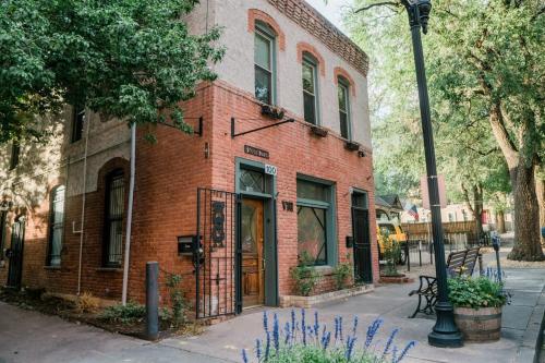 a brick building with a clock on the side of it at Miners Escape - Timeless District Cozy Haven in Colorado Springs