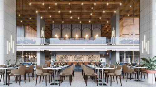 a restaurant with tables and chairs in a building at Akara Hotel Pattaya in Pattaya North