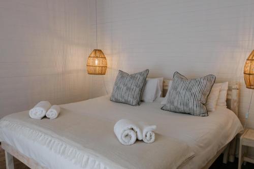 a bedroom with a bed with towels on it at Fritz Manor Bed and Breakfast in Swakopmund