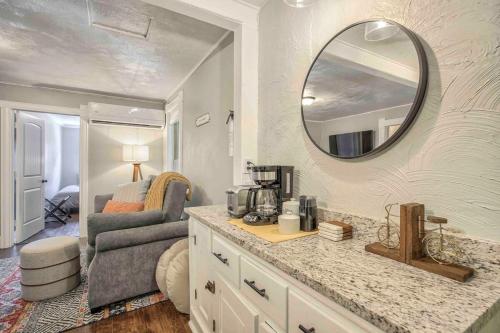 a kitchen with a counter and a mirror on the wall at Miners Escape - Timeless District Cozy Haven in Colorado Springs