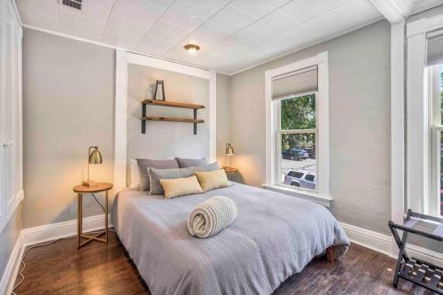 a bedroom with a large bed and a window at Miners Escape - Timeless District Cozy Haven in Colorado Springs