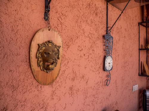 a wall with a mirror and a clock on a wall at Agafay Olivium 