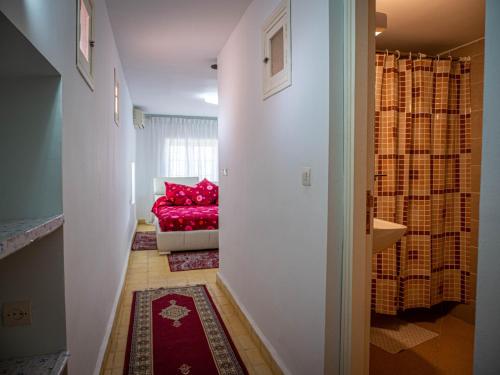 a hallway with a red couch in a room at Agafay Olivium 