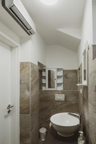 a bathroom with a white sink and a toilet at Villa Nika in Klimno