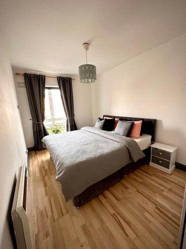 a bedroom with a large bed and a chandelier at Riverview Apartment in Dublin