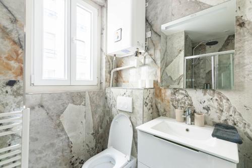 a bathroom with a toilet and a sink at Luxurious 1 Bedroom Quartier de la Bastille Free Netflix in Paris