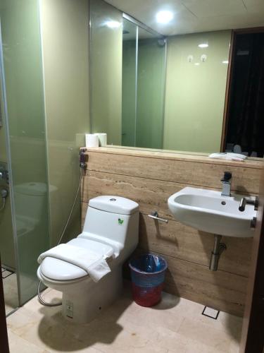 a bathroom with a toilet and a sink at Vortex Suites KLCC by Luna in Kuala Lumpur