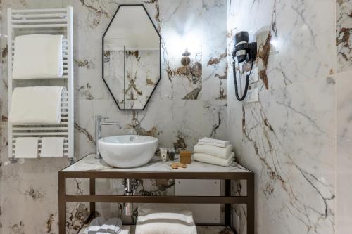 a bathroom with a sink and a mirror at Acca Hotel in Venice