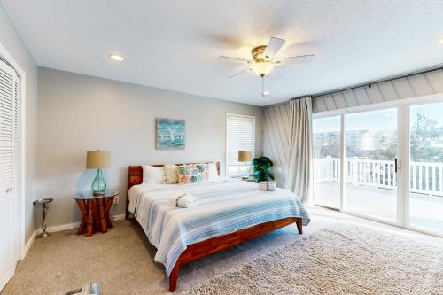維吉尼亞海灘的住宿－Beach Shell-A，一间卧室配有一张带吊扇和窗户的床。