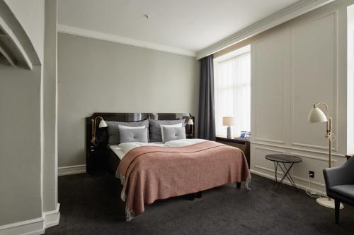 a bedroom with a large bed and a window at Hotel Skt. Annæ in Copenhagen