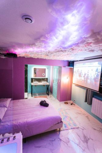 a bedroom with a bed and a projection screen at Capsule cloud - jacuzzi - projecteur cinema in Tourcoing