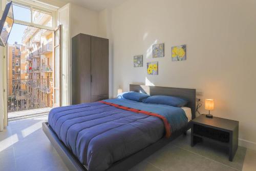 a bedroom with a large bed and a large window at B&B Salerno Centrale in Salerno
