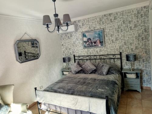 a bedroom with a bed and a chandelier at Apartment in Gallinaro with stunning views in Gallinaro