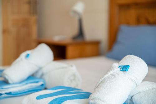 a pair of white socks on a bed at Ta' Pupa Farmhouse - Sannat in Sannat