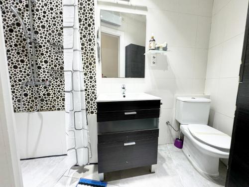 a bathroom with a sink and a toilet and a shower at Luminoso, con patio y buena zona in Madrid