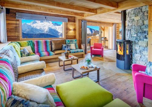 a living room with a couch and a fireplace at Chalet Nougat - Les Congères in Manigod