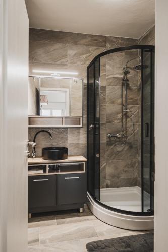 a bathroom with a shower and a sink at Villa Sabrina in Klimno