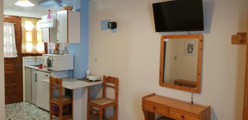 a small kitchen with a counter and a microwave at Iasonas Rooms in Agios Kirykos