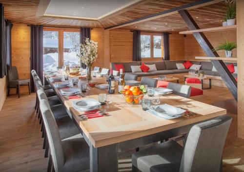 a large wooden table in a room with a couch at Chalet Guimauve - Les Congères in Manigod