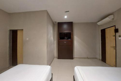 Ένα ή περισσότερα κρεβάτια σε δωμάτιο στο Hotel Bumi Malaya