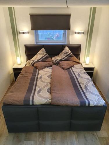 a bed in a bedroom with two pillows on it at Fuchsbau Haasow in Haasow