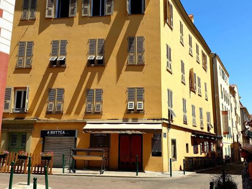 a large yellow building with a lot of windows at Appartement Casa Niculetta in Ajaccio
