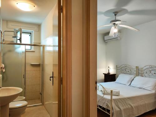 a bedroom with a bed and a bathroom with a sink at The Lookout in Marina Porto