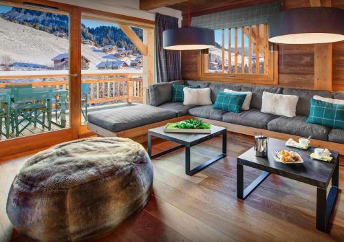 a living room with a couch and a table at Chalet Meringue - Les Congères in Le Grand-Bornand