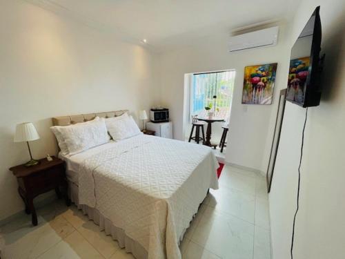 a bedroom with a bed and a television in it at Residence Pipa Beach in Pipa