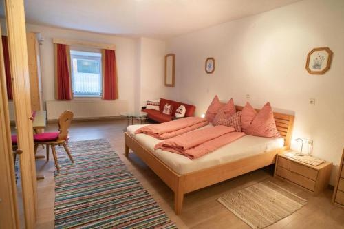 a bedroom with a bed with orange pillows on it at Penznhof 