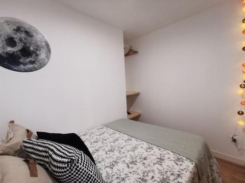 ein Schlafzimmer mit einem Bett und einem Mond an der Wand in der Unterkunft Ores du Roussillon grand studio climatisé extérieur in Villeneuve-lès-Avignon