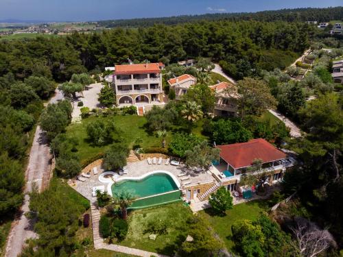 an aerial view of a house with a swimming pool at Sanidiamonds in Sani Beach