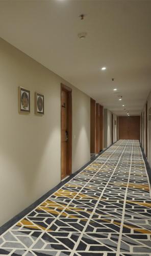a hallway with a tile floor in a building at Hotel Alwar Royals in Alwar