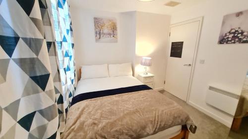a small bedroom with a bed in a room at Excellent 2 Bedroom City Centre Apartment in Sheffield